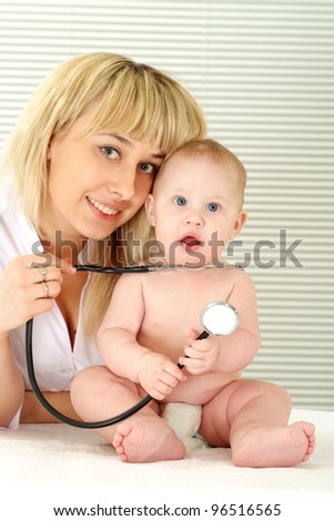 portrait of a cute doctor with baby