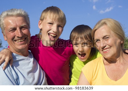Bliss Caucasian grandparents with grandchildren with fool on the street