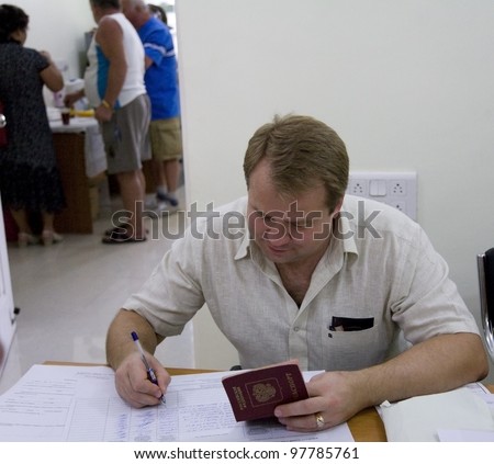 GOA, INDIA - MARCH 4: Russian clerk  fill list  of voted people during election of Russian president on March 4, 2012 in Goa, India.