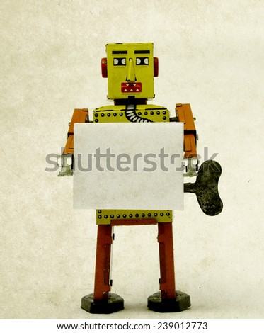 robot toy holding a sign