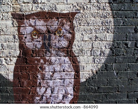 old brick wall with owl and moon