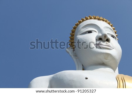 Portrait of a Buddha statue. Blue sky background