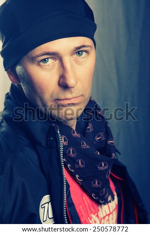 Portrait of a man with a scarf and cap