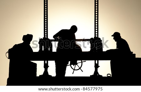 Silhouettes of workers at work in the evening