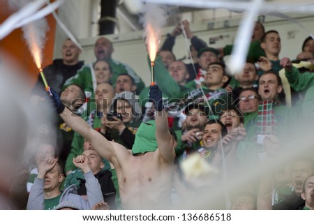 LUBIN, POLAND - APRIL 28: Fans of Slask smoke flares and throwing serpentines during match Polish Premier League KGHM Zaglebie Lubin - WKS Slask Wroclaw (4:0) on April 28, 2013 in Lubin, Poland.