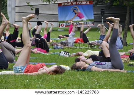 WROCLAW, POLAND - JULY 7: People practicing yoga in the park as part of \