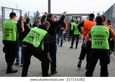 LUBIN, POLAND - SEPTEMBER 12, 2014: FEBRUARY 16; 2014: Security searches supporters at the entrance to the stadium before match Polish 1 League between KGHM Zaglebie Lubin - Chrobry Glogow (1:0).