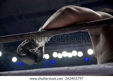 boxer\'s hand on the ring rope