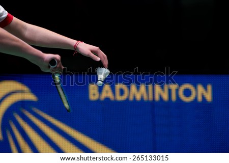 Hand of badminton player with racket and shuttlecock