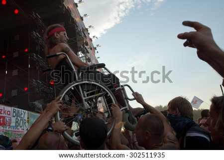 Kostrzyn Nad Odra, Poland. 30th JULY, 2015. Fans carry disabled man during concert Polish band PRoletaryat at the 21 Festival Przystanek Woodstock. It is the biggest open music festival in Europe.