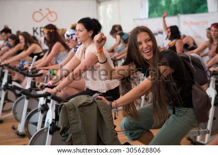 Kostrzyn Nad Odra, Poland. 30th JULY, 2015. People riding on stationary bikes in a Allegro tent during 21 Festival Przystanek Woodstock.