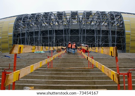 GDANSK, POLAND - MARCH 18: Construction workers walk up the stairs at stadium PGE Arena on March 18, 2011 in Gdansk, Poland. 448 days left before Euro 2012 starts.