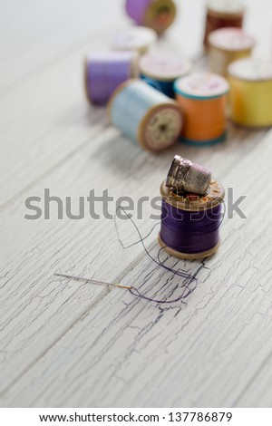 Cotton reels, needle and thread