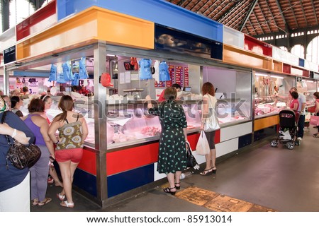 MALAGA, SPAIN - JUNE 10: Unidentified sellers pack meat at their shop in the popular central market on June 10, 2011 in Malaga, Spain.   It was renovated in 2010 and it was reopened on March 2011.