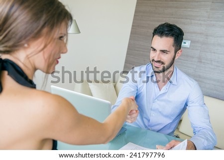 Man and Woman giving Handshake at Office