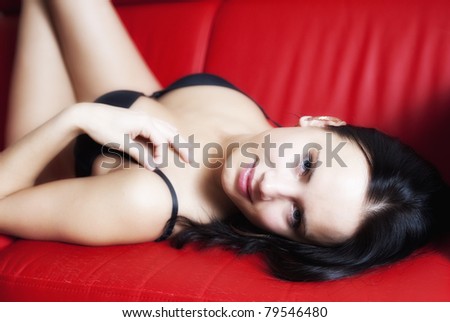 Woman on red sofa