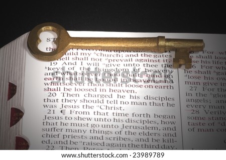 Skeleton key on bible open to reference about Keys of the kingdom. Passage is spotlighted.
