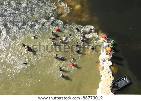 BANGKOK, THAILAND - NOVEMBER 13: Water barrier are destroyed by group of people to open the water flow to the opposite during the worst flooding in decades in Bangkok, Thailand on November 13, 2011.