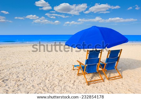 Beach chairs and umbrella at a tropical resort