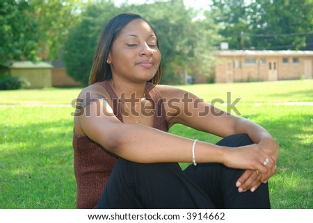 a picture of a beautiful woman meditating in the shade