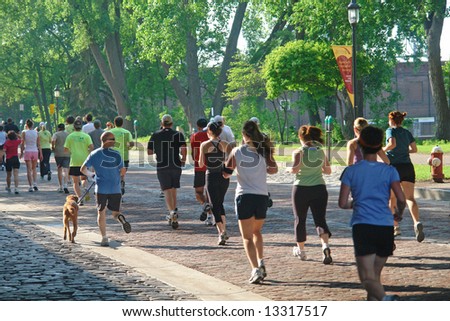 A picture of runners on beautiful summer day in park