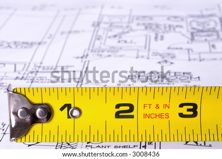 Steel Tape Measure in Front of Blueprints