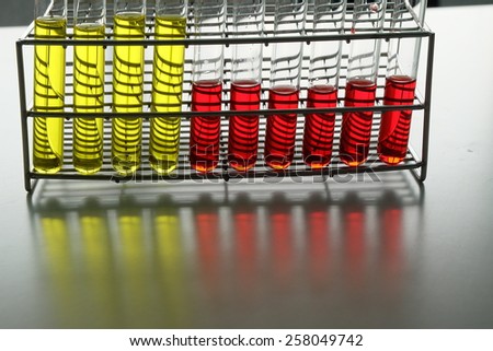Colorful fluid in bottom and test tube for laboratory use on table laboratory