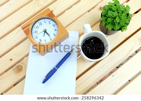 Blank paper and office tools on the wood table with black coffee