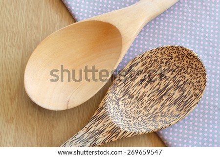 wooden spoon on wooden and dot cloth background