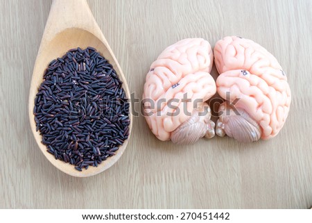 brain and purple rice on wooden background with eat clean concept