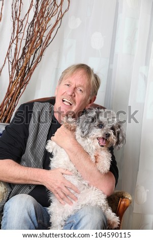 man with his dog on a sofa