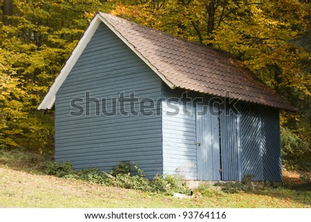 closeup of a blue old wooden tool shed