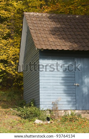 closeup of a blue old wooden tool shed