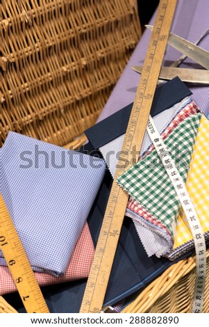 Brightly Colored Swatches in Wicker Basket with Wooden Rulers, Measuring Tape and Scissors