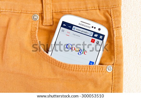 LVIV, UKRAINE - May 19, 2015: white Samsung Smart Phone with Google search site in orange jeans pocket