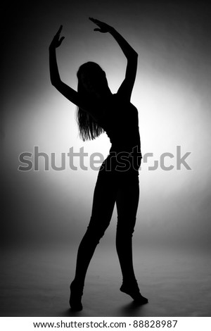 Silhouette of young woman in dance pose