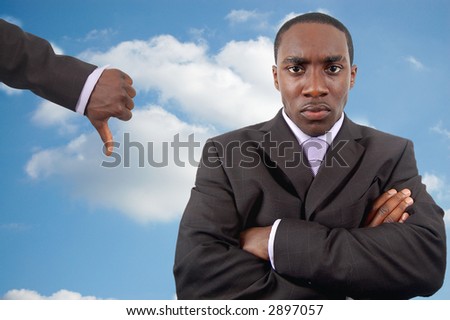 This is an image of an angry businessman who is trying to manage his anger. The thumbs down is a sign of discouragement. This image can be used to represent \