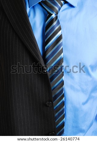 This is a an image of business man wearing a tie, shirt and a partially worn suit.