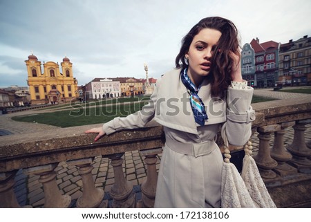 Beautiful and fashion young woman posing with street.Fashion colors.Wide angle.
