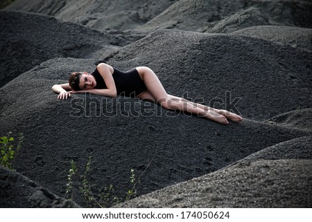 fashion portrait of sexy girl in bikini lying at desert.Fashion photo.