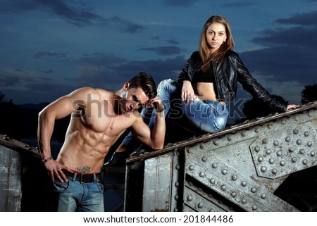 Outdoor natural portrait of a gorgeous couple fitness models.Gymnastics girl.Fashion colors.