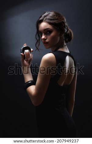Elegant sensual young woman holding perfume, Beautiful woman face. Perfect makeup. Beauty fashion. Fashion photo