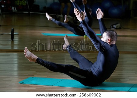 fusion of mind and body - man practicing pilates