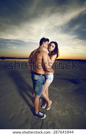 young couple in love having holidays on the sea. Fashion colors.Wide angle.