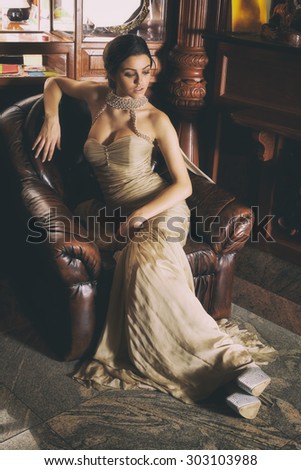 Glamour lady portrait in luxury dress. Beautiful model girl with perfect fashion makeup and hairstyle. Eelegant girl, in a luxury interior.