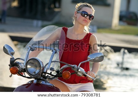 Portrait of smiling girl on scooter - Outdoor on street .Retro shot. Fashion art photo