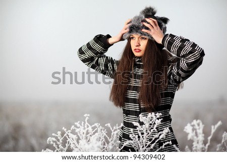 A beautiful brunette woman posing in the winter.Art photo.