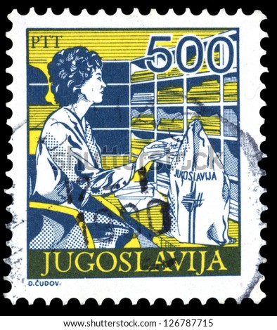 YUGOSLAVIA - CIRCA 1986: Stamp printed in Yugoslavia shows a Postal employee sorting mail, without inscription, from series \