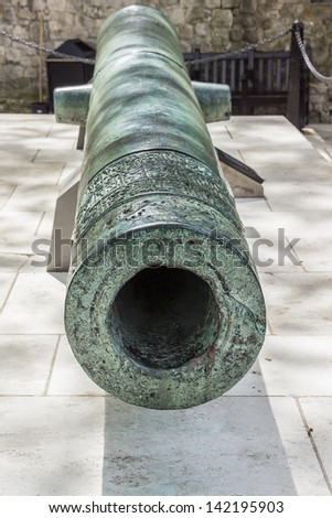Old battle cannon in Tower of London - historic castle on the north bank of the River Thames in central London - a popular tourist attraction.