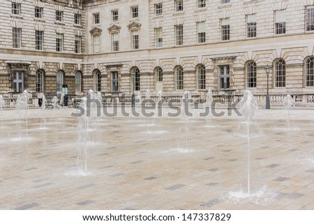 Somerset House - large Neoclassical building (design Sir William Chambers, 1776) in central London, overlooking River Thames. Fountains. Somerset House - one of major art and culture center in London.